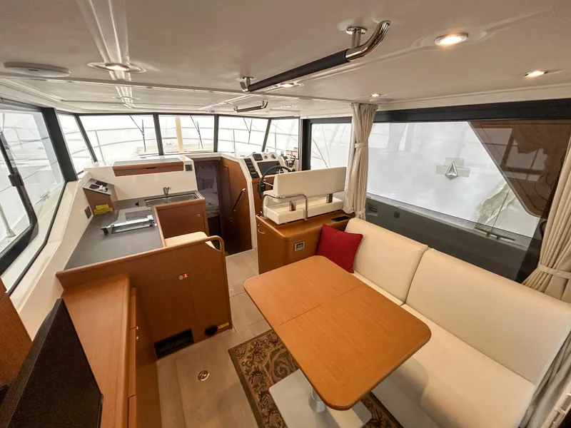 Slide: The Image of 2023 Beneteau Swift Trawler 35 interior with modern kitchen and cozy seating area. - 11