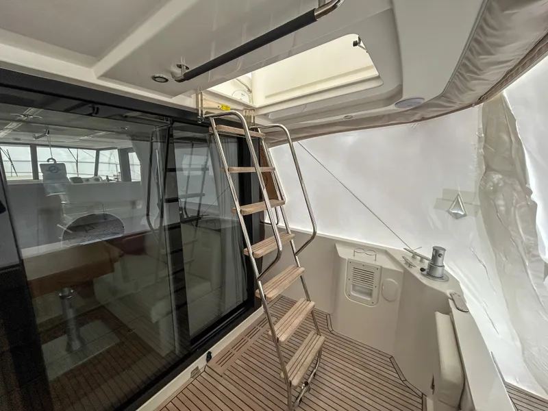 Slide: The Image of Interior view of 2023 Beneteau Swift Trawler 35 with ladder and seating area. - 3