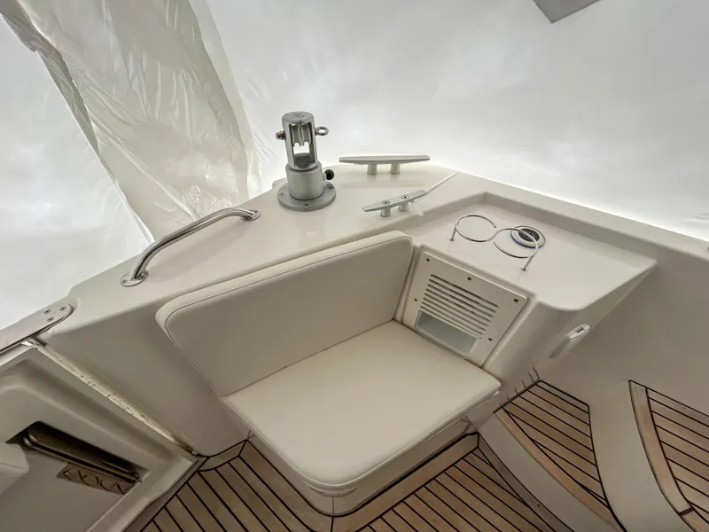 Slide: The Image of 2023 Beneteau Swift Trawler 35 deck with seating and teak flooring. - 4