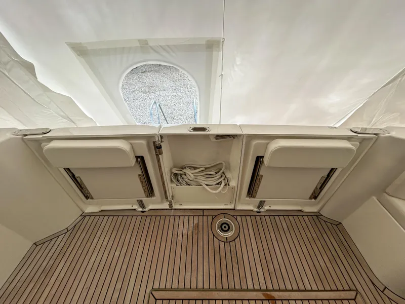 Slide: The Image of 2023 Beneteau Swift Trawler 35 deck with teak flooring and storage compartments. - 7