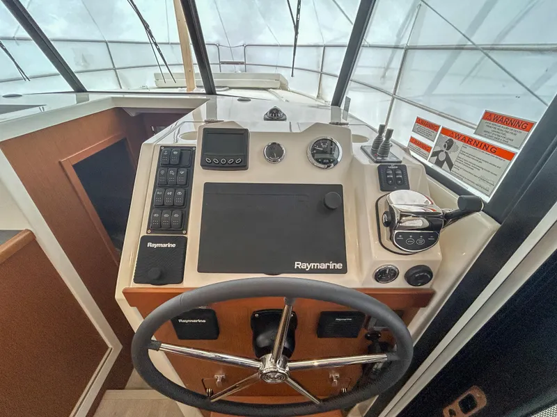 Slide: The Image of 2023 Beneteau Swift Trawler 35 helm with Raymarine navigation system. - 9