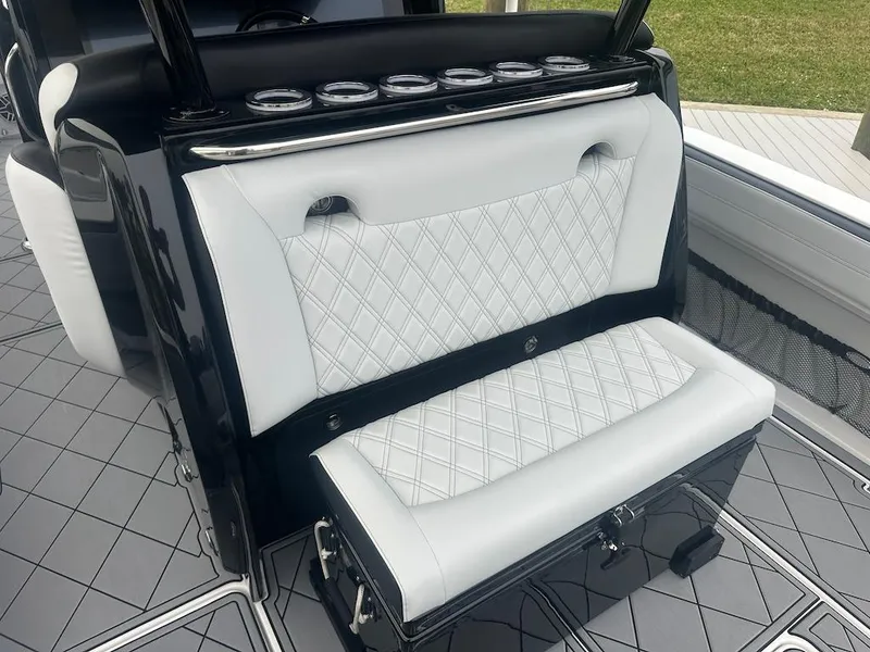 Slide: The Image of 2024 Nor-Tech 340 Sport Center Console with white diamond-stitched seating and sleek black accents. - 11