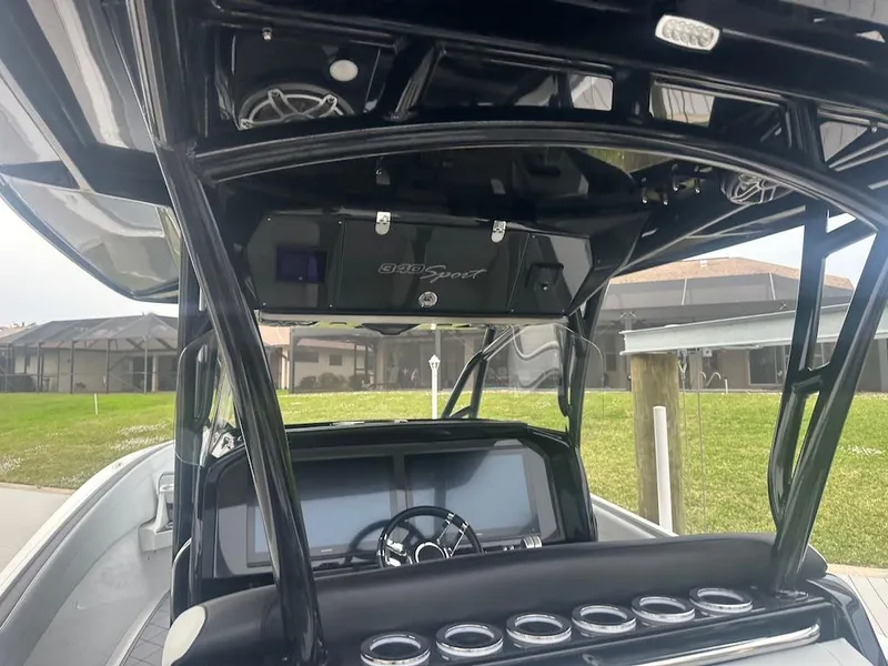 Slide: The Image of 2024 Nor-Tech 340 Sport Center Console boat interior with sleek dashboard and steering wheel. - 12