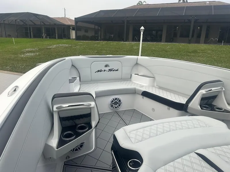 Slide: The Image of 2024 Nor-Tech 340 Sport Center Console interior with white seating and cup holders. - 17