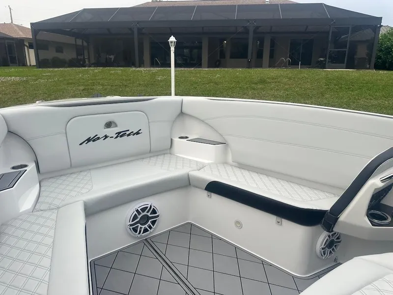 Slide: The Image of 2024 Nor-Tech 340 Sport Center Console interior with white seating and modern design. - 18