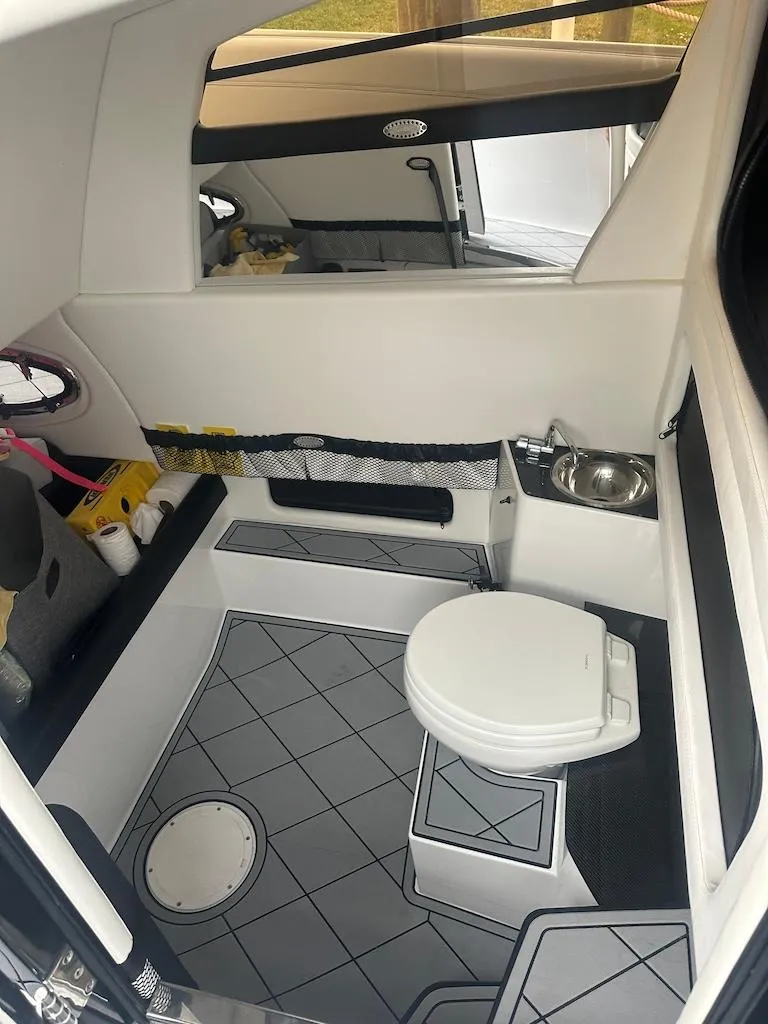 Slide: The Image of 2024 Nor-Tech 340 Sport Center Console interior with modern bathroom amenities. - 2