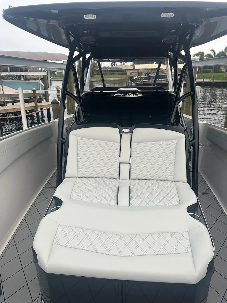 Slide: The Image of 2024 Nor-Tech 340 Sport Center Console boat with luxurious seating and sleek design. - 20