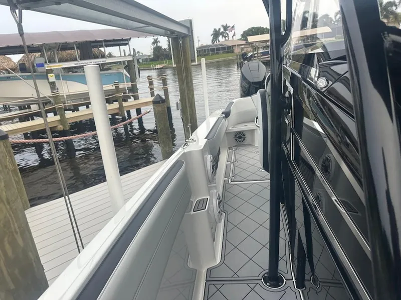 Slide: The Image of 2024 Nor-Tech 340 Sport Center Console docked at marina, side view. - 21