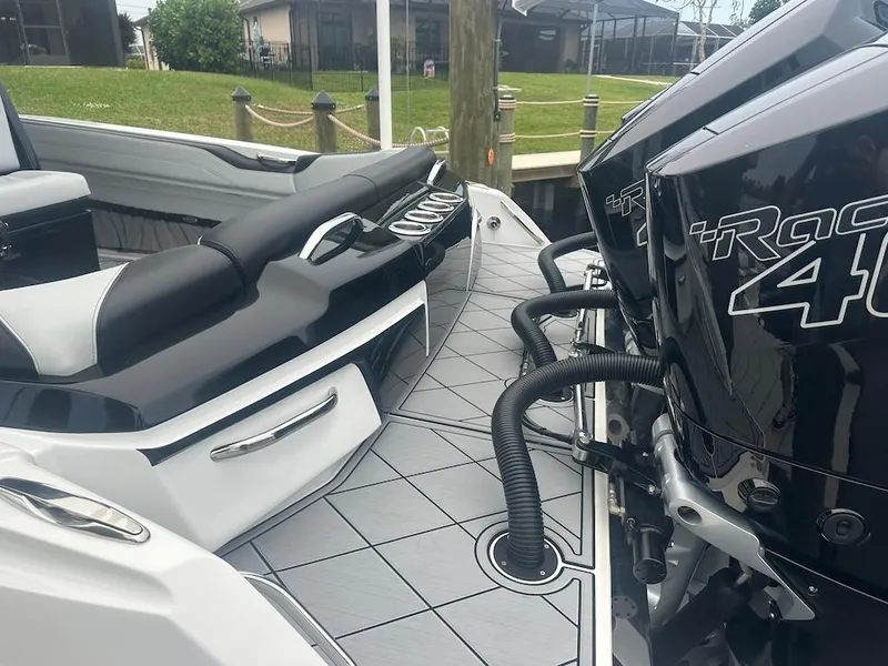 Slide: The Image of 2024 Nor-Tech 340 Sport Center Console with powerful outboard engines docked. - 22