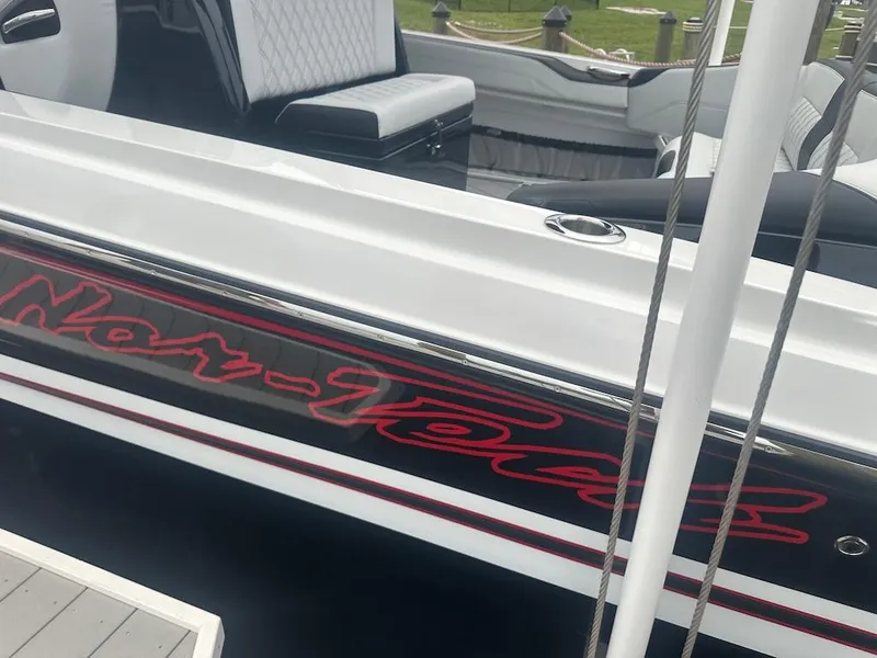 Slide: The Image of 2024 Nor-Tech 340 Sport Center Console boat with sleek design and modern seating. - 25