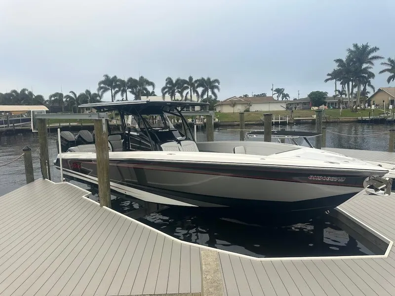 Slide: The Image of 2024 Nor-Tech 340 Sport Center Console docked at marina with palm trees in background. - 29