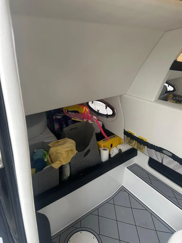 Slide: The Image of 2024 Nor-Tech 340 Sport Center Console interior storage area with organized supplies. - 3
