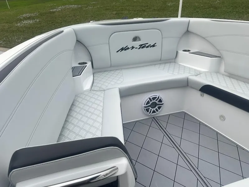 Slide: The Image of 2024 Nor-Tech 340 Sport Center Console interior with white seating and speaker. - 5