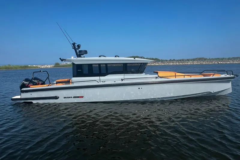 Slide: The Image of 2024 BRABUS Shadow 900 XC Cross Cabin boat on calm water, side view. - 1