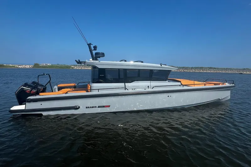 Slide: The Image of 2024 BRABUS Shadow 900 XC Cross Cabin boat on calm water, side view. - 2
