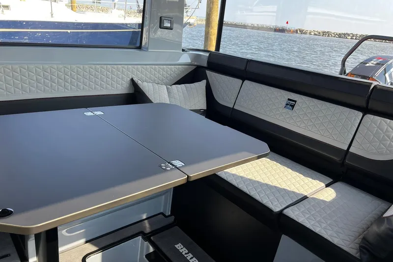 Slide: The Image of Luxurious interior of 2024 BRABUS Shadow 900 XC Cross Cabin with quilted seating and table. - 28