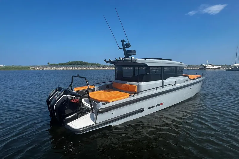 Slide: The Image of 2024 BRABUS Shadow 900 XC Cross Cabin boat on calm water, featuring sleek design and powerful engines. - 3