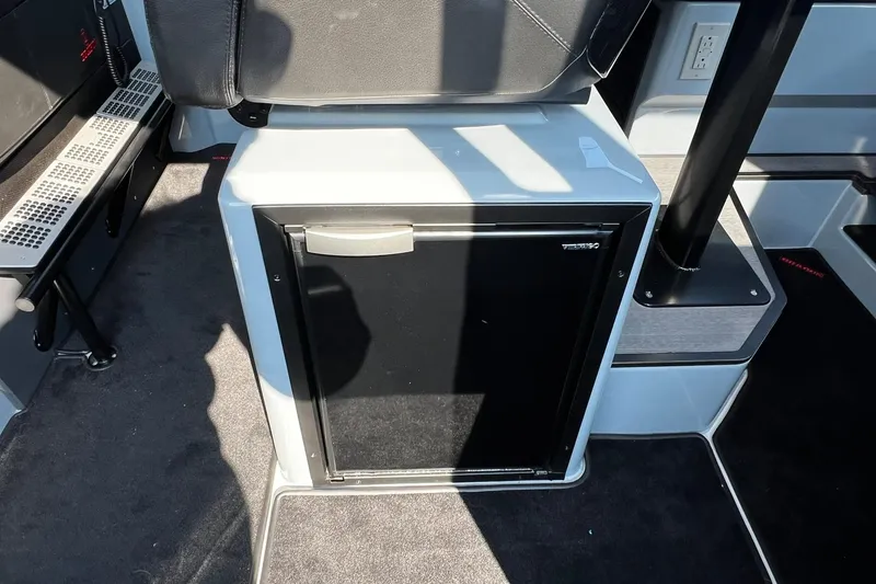 Slide: The Image of 2024 BRABUS Shadow 900 XC Cross Cabin interior with compact fridge and seating. - 30