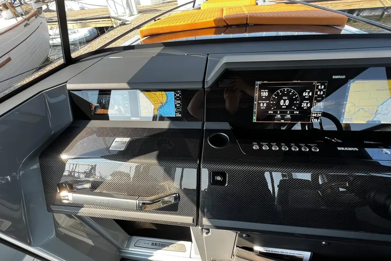 Slide: The Image of 2024 BRABUS Shadow 900 XC Cross Cabin dashboard with advanced navigation displays and controls. - 33