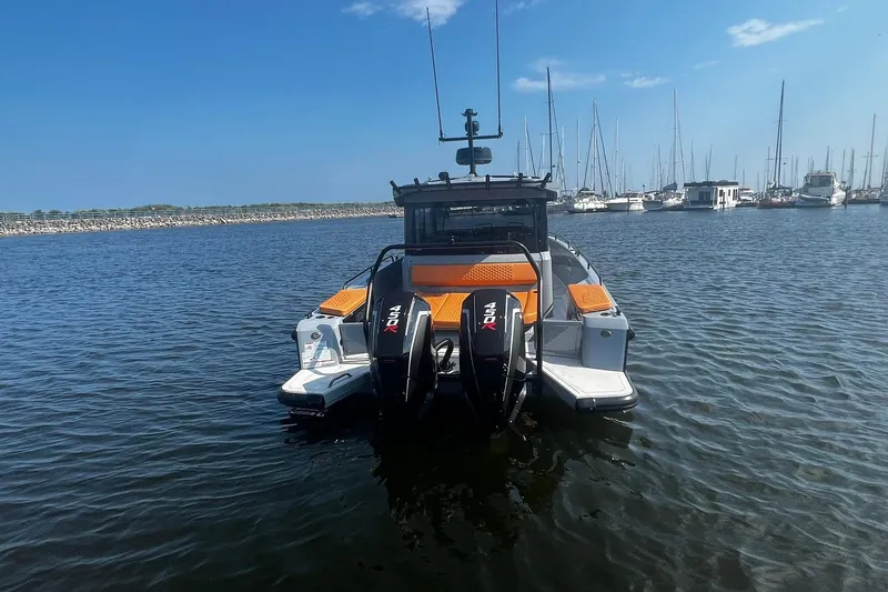 Slide: The Image of 2024 BRABUS Shadow 900 XC Cross Cabin boat docked in marina, rear view. - 5