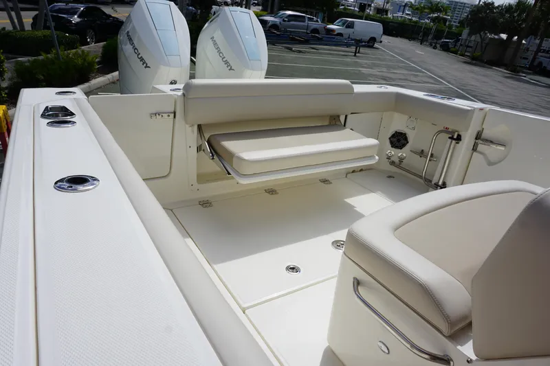 Slide: The Image of 2026 Boston Whaler 330 Outrage boat interior with seating and dual Mercury engines. - 10