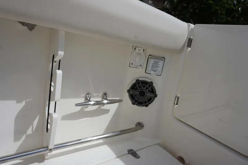 Slide: The Image of 2026 Boston Whaler 330 Outrage interior detail with speaker and cleat. - 14