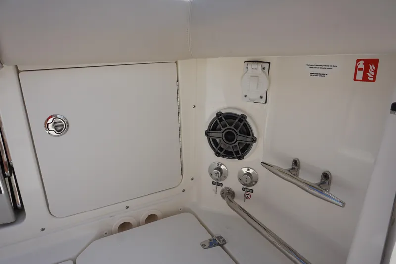Slide: The Image of 2026 Boston Whaler 330 Outrage boat interior with speaker, storage, and safety features. - 15