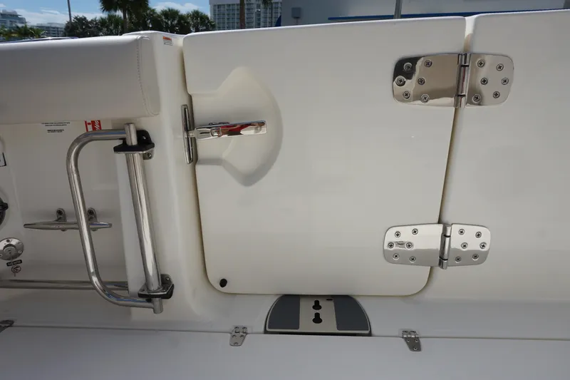 Slide: The Image of 2026 Boston Whaler 330 Outrage boat door with stainless steel hinges and handle. - 16