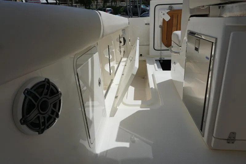 Slide: The Image of 2026 Boston Whaler 330 Outrage interior with storage compartments and sleek design. - 18