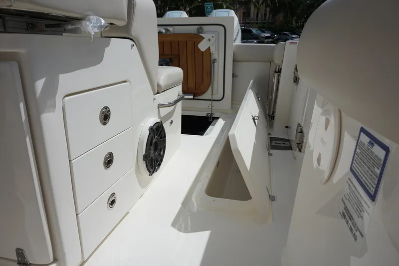 Slide: The Image of 2026 Boston Whaler 330 Outrage interior with storage compartments and seating. - 19