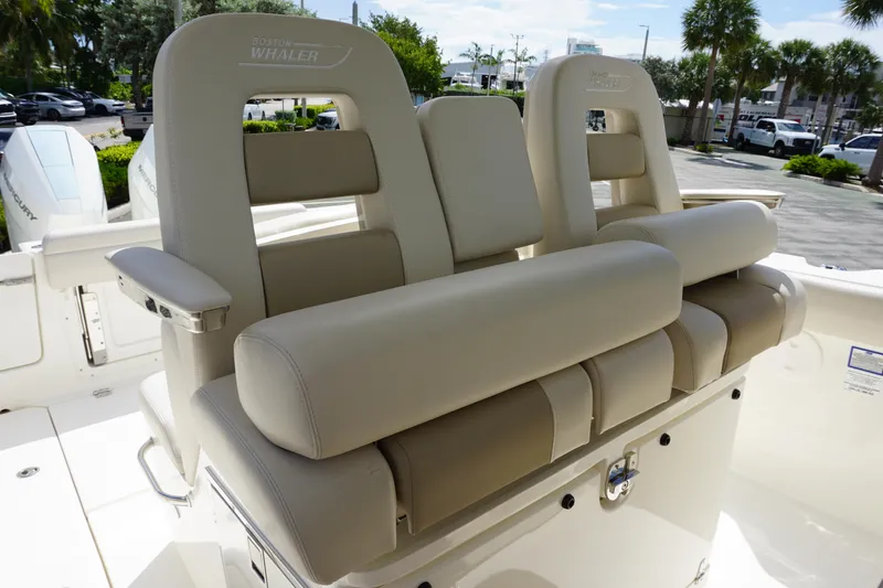 Slide: The Image of 2026 Boston Whaler 330 Outrage boat seating with luxurious beige upholstery. - 20