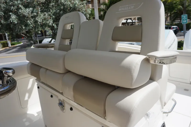 Slide: The Image of 2026 Boston Whaler 330 Outrage boat seats with luxurious beige upholstery. - 21