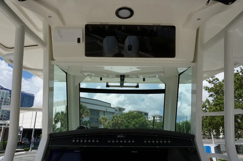 Slide: The Image of 2026 Boston Whaler 330 Outrage helm with modern controls and panoramic view. - 22