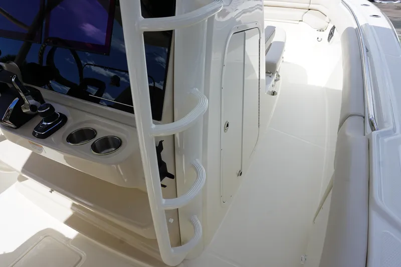 Slide: The Image of 2026 Boston Whaler 330 Outrage boat interior with control panel and seating area. - 23