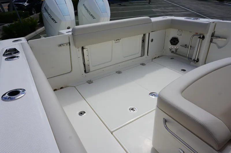 Slide: The Image of 2026 Boston Whaler 330 Outrage boat interior with seating and storage compartments. - 8