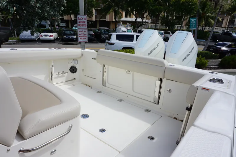Slide: The Image of 2026 Boston Whaler 330 Outrage boat interior with seating and Mercury engines. - 9