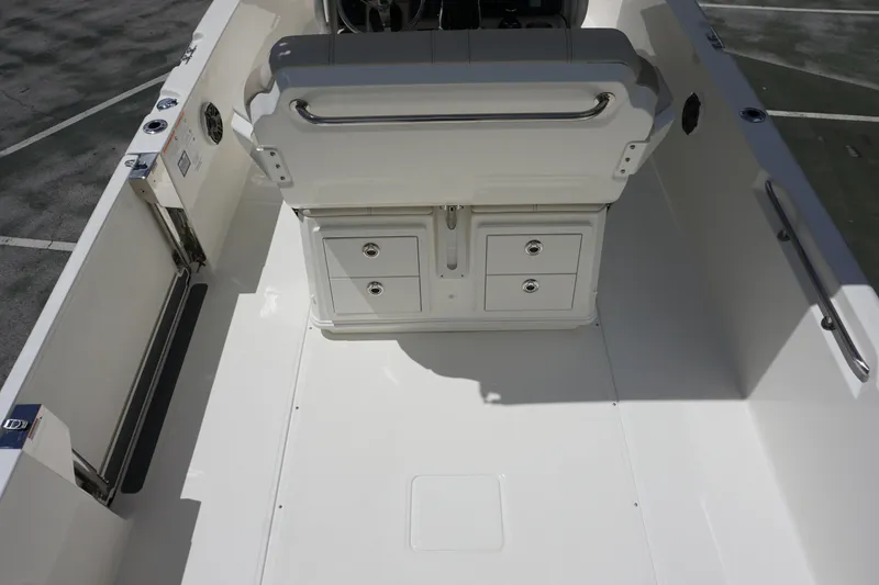 Slide: The Image of 2026 Boston Whaler 280 Dauntless interior with storage compartments and seating. - 14
