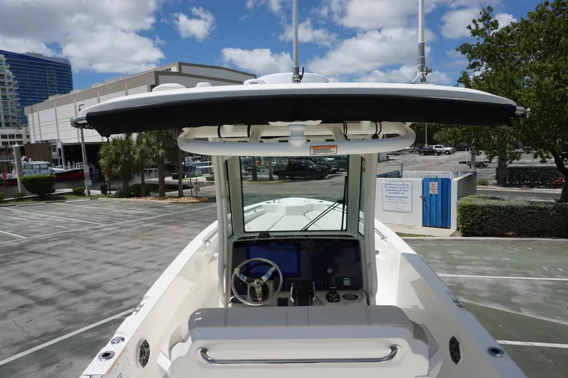 Slide: The Image of 2026 Boston Whaler 280 Dauntless boat with modern helm, parked in urban setting. - 16
