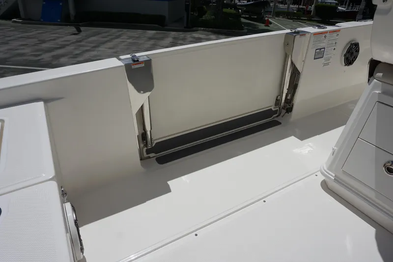 Slide: The Image of 2026 Boston Whaler 280 Dauntless interior, featuring sleek white deck and storage compartments. - 17