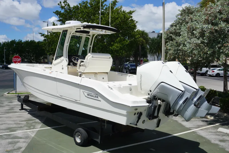 Slide: The Image of 2026 Boston Whaler 280 Dauntless boat with dual outboard engines on display. - 2