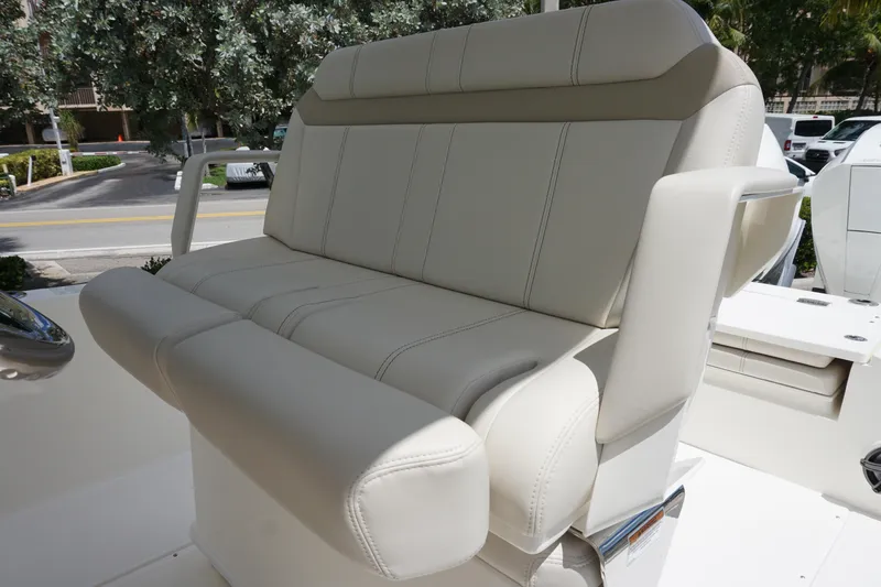 Slide: The Image of 2026 Boston Whaler 280 Dauntless boat seat, featuring luxurious white upholstery and armrests. - 25