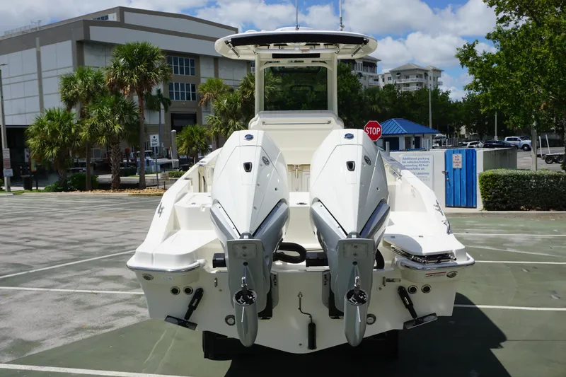 Slide: The Image of 2026 Boston Whaler 280 Dauntless boat with dual engines, parked outdoors. - 3