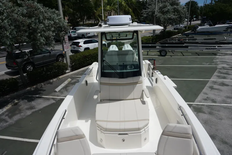 Slide: The Image of 2026 Boston Whaler 280 Dauntless boat in parking lot, showcasing sleek design and seating. - 31
