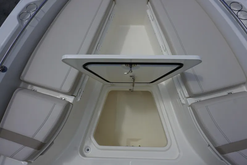 Slide: The Image of 2026 Boston Whaler 280 Dauntless boat storage compartment with cushioned seating. - 35