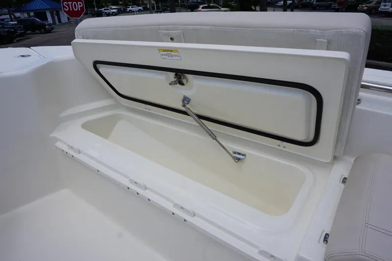 Slide: The Image of 2026 Boston Whaler 280 Dauntless boat storage compartment open, showcasing interior space. - 36
