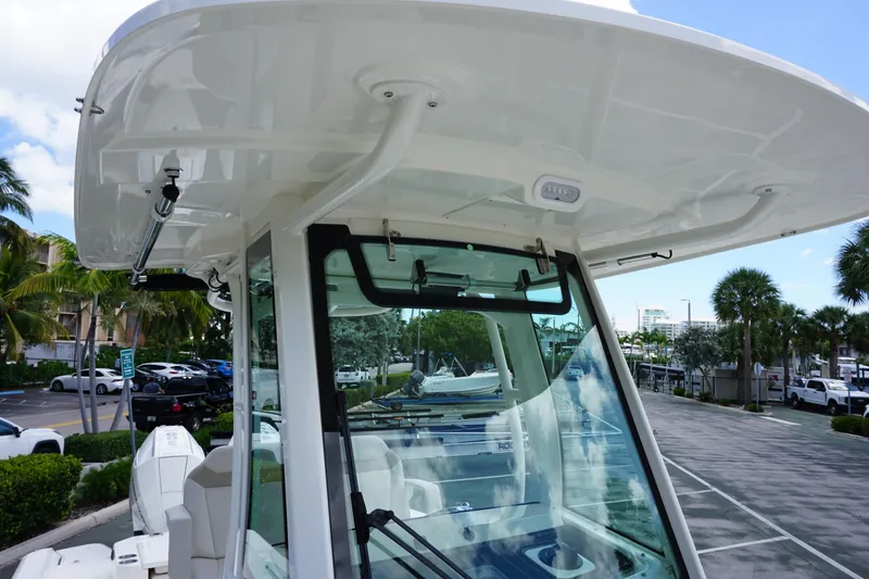 Slide: The Image of 2026 Boston Whaler 280 Dauntless boat with T-top and windshield, parked outdoors. - 39