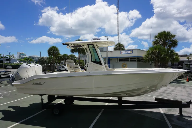 Slide: The Image of 2026 Boston Whaler 280 Dauntless boat on trailer under blue sky. - 4