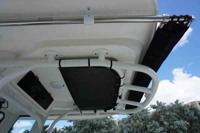 Slide: The Image of 2026 Boston Whaler 280 Dauntless boat canopy and rod holder against blue sky. - 41