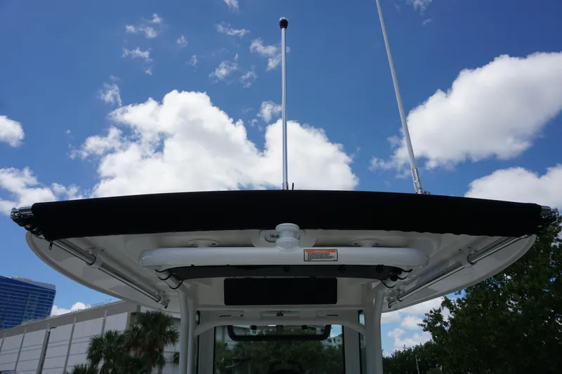 Slide: The Image of 2026 Boston Whaler 280 Dauntless boat canopy against blue sky with clouds. - 42