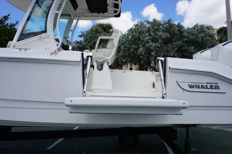 Slide: The Image of 2026 Boston Whaler 280 Dauntless boat, side view with seating and logo. - 45